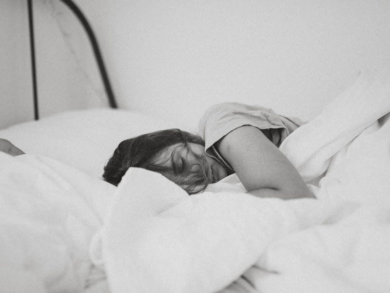 Woman sleeping deeply in a bed